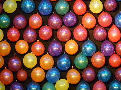 assorted-color balloons on wall thumbnail