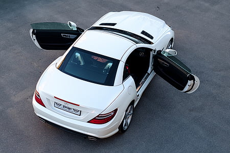 aerial photography of white coupe on concrete road thumbnail