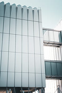 grey high-rise building below bright sky thumbnail