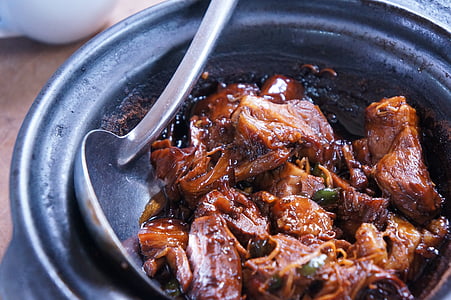 meat dish with brown sauce inside cauldron thumbnail