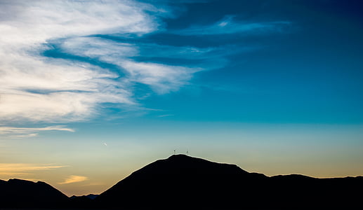 silhouette of mountain under cloudy sky thumbnail