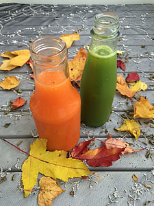 two clear glass bottles beside leaves thumbnail