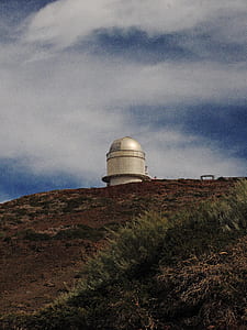 white factory on hill thumbnail
