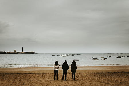 Three Person Standing Near the Seashore thumbnail