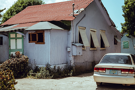 silver Nissan sedan near building thumbnail