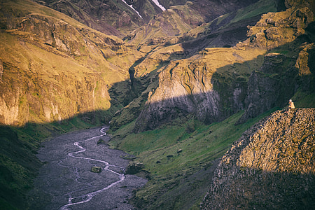 high angle photography of lake between mountain cliffs thumbnail