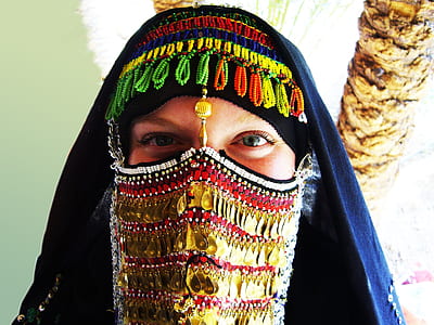 woman covered her face with sequined mask and headdress thumbnail