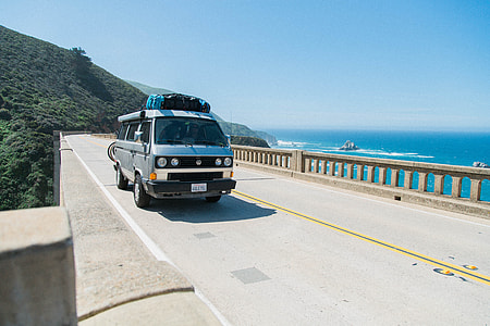 gray bus on bridge beside body of water thumbnail