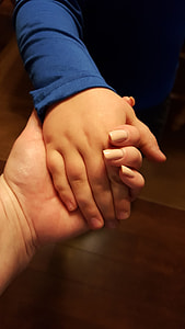 closeup photo of person wearing blue long-sleeve top holding hands thumbnail