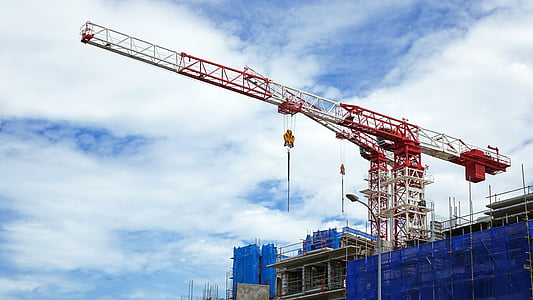 white and red metal crane under white clouds during daytime thumbnail