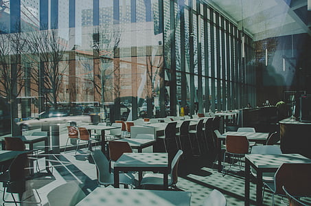white-and-brown wooden dining sets inside building thumbnail