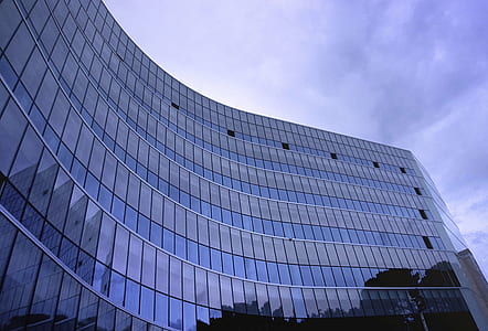 Fish Eye View Photo of Glass High Story Building over White Cloudy Sky during Daytime thumbnail