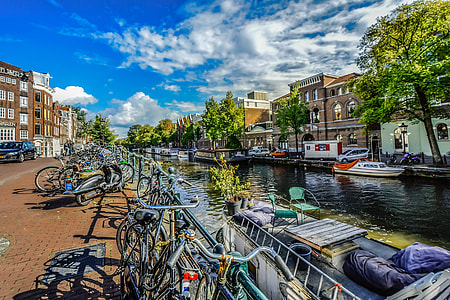 assorted-color bikes parked near body of water thumbnail