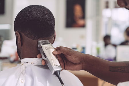 man trimming his person's hair thumbnail