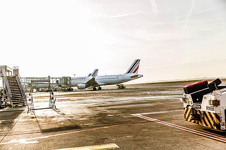 white and gray airplane on gray pavement during daytime thumbnail