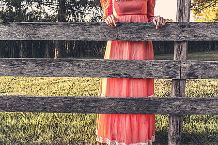 woman leaning on gray wooden fence thumbnail