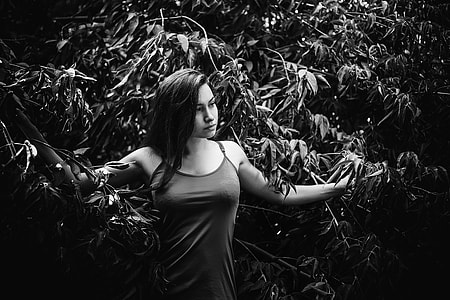 greyscale photography of woman near plants thumbnail