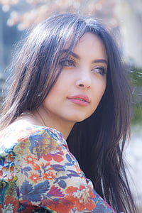 woman wearing floral shirt looking sideway thumbnail