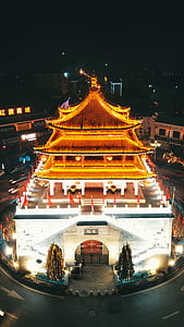 lit structure surrounded by structures thumbnail