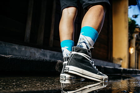 person wearing black high-top shoes thumbnail