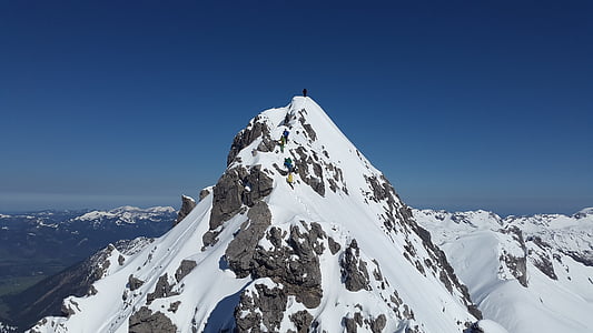 person standing on mountain peak thumbnail