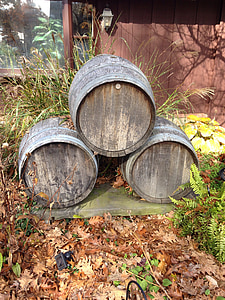 three stacked brown wooden barrels on brown wooden platform during daytime thumbnail