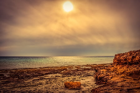 rock formation near body of water thumbnail