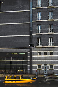 yellow boat beside building thumbnail