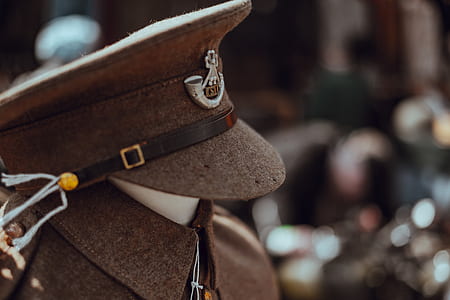 tilt shift of brown Officer's cap and uniform thumbnail