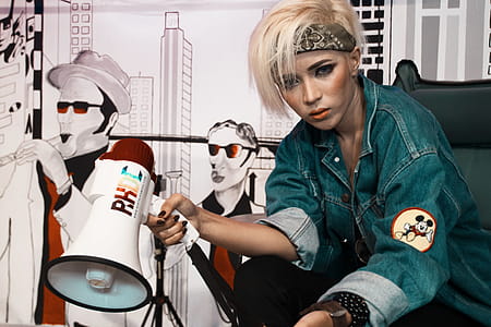 Woman Holding White and Red Megaphone thumbnail