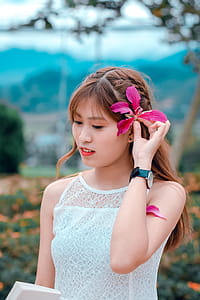 Brown Haired Woman in White Sleeveless Top in Bokeh Photography thumbnail