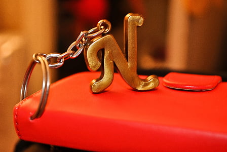 selective focus photography of gold-colored N key chain thumbnail