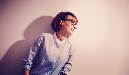 woman wearing black-framed eyeglasses and blue button-up long sleeved shirt thumbnail