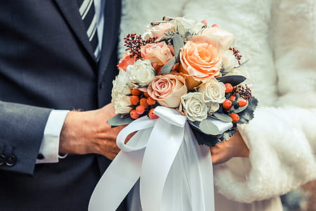 bride and groom holding bouquet of rose flowers thumbnail