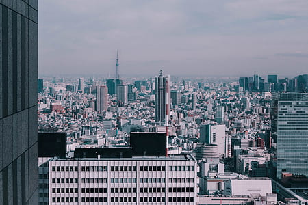 aerial view photography of city buildings under cloudy sky thumbnail