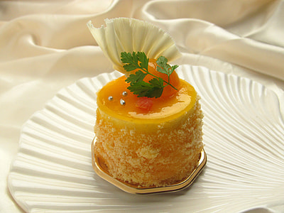 yellow cake on white shell shape ceramic plate thumbnail