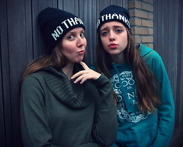 two women wearing jackets while pouting their lips thumbnail