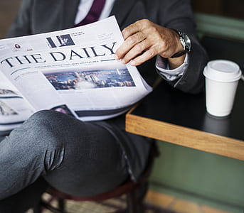 person reading The Daily newspaper thumbnail
