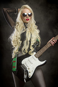 woman in black mesh top and black stocking standing black holding white stratocaster electric guitar thumbnail