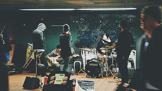 band performing on stage near door thumbnail