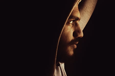 man facing left side with black background thumbnail