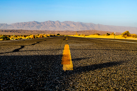 gray asphalt road with yellow paint during daytime thumbnail