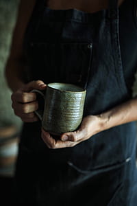person's hand holding mug thumbnail