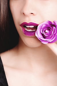 Woman Wearing Black Top Holding Purple Rose Flower thumbnail