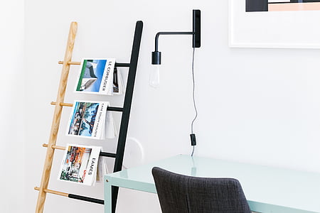 magazines on rack beside wall thumbnail