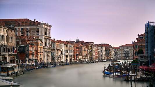 brown concrete buildings near body of water thumbnail