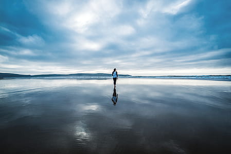 person standing on body of water during daytime thumbnail