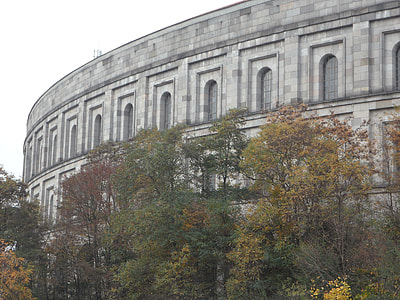architectural photography of gray concrete building surrounded by green leafed trees thumbnail