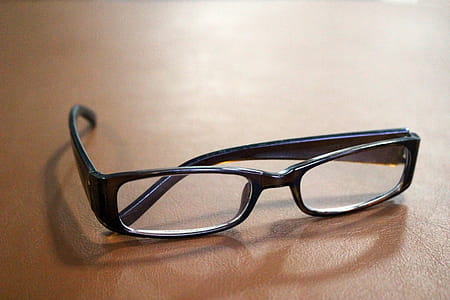 Pair of reading glasses on a table thumbnail