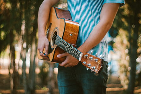 man holding acoustic guitar thumbnail